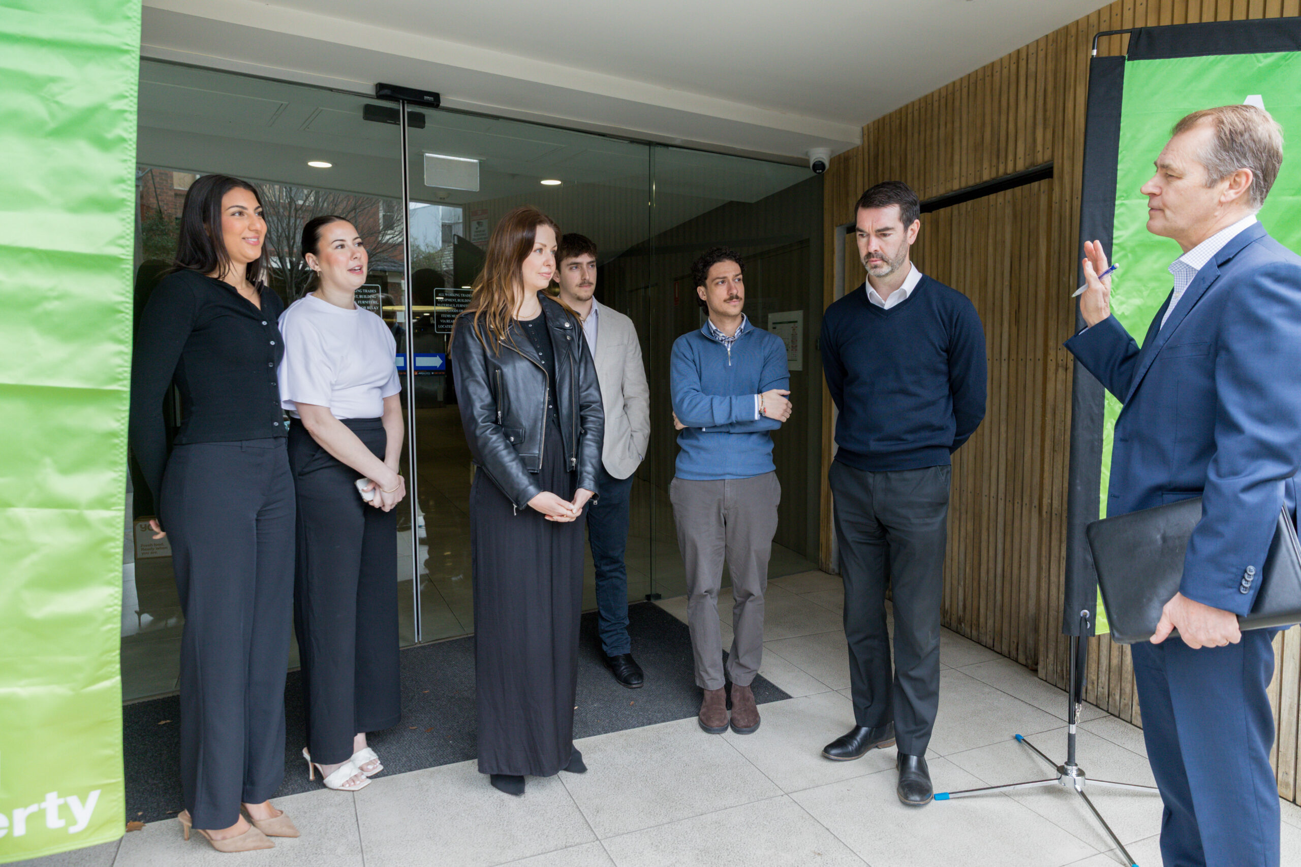 Andrew Wood speaking with the Wood Property team at a Melbourne apartment building